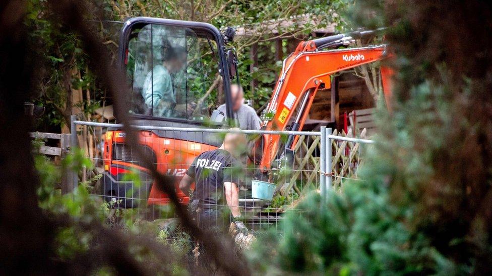 Officials searching an allotment near Germany