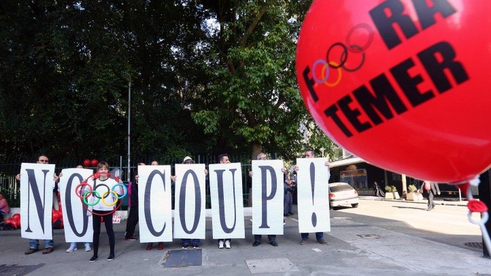 Supporters of suspended Brazilian President Dilma Rousseff protest against the government of interim President Michel Temer before the relay of the Olympic flame at Paulista Avenue in Sao Paulo"s financial center, Brazil, July 24, 2016