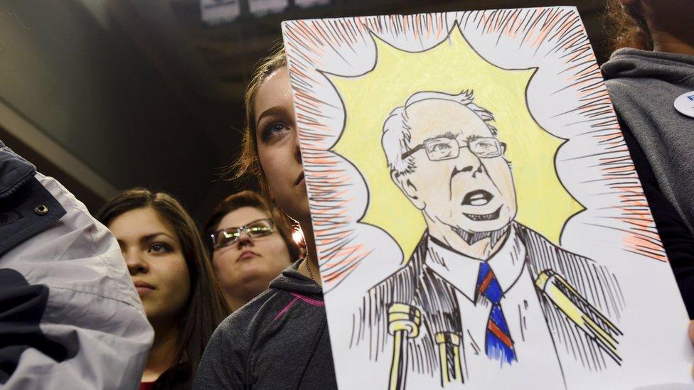 A woman holds a drawing of Democratic U.S. presidential candidate Bernie Sanders as he speaks at a campaign rally at the University of Wisconsin-Green Bay campus in Green Bay, Wisconsin April 1, 2016.