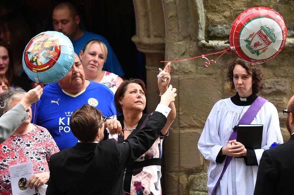 Sally Stokes (centre) releases balloons after the funeral of her sons Matthew and Adam at St Mary's Church, Hinckley, Leicestershire