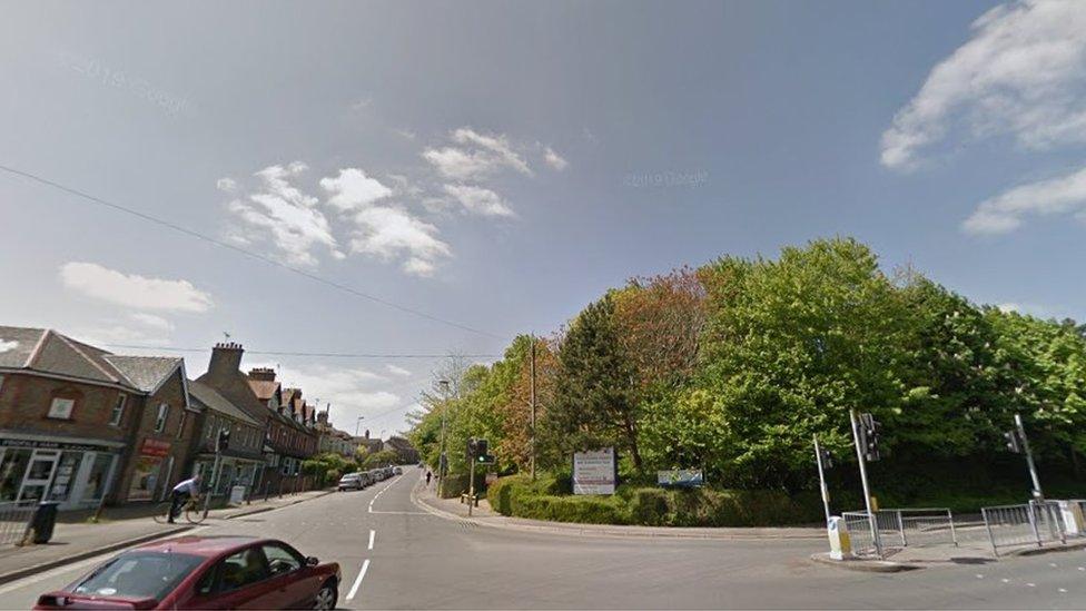 Junction of Damers Road and Williams Avenue in Dorchester lined with trees and Victorian houses