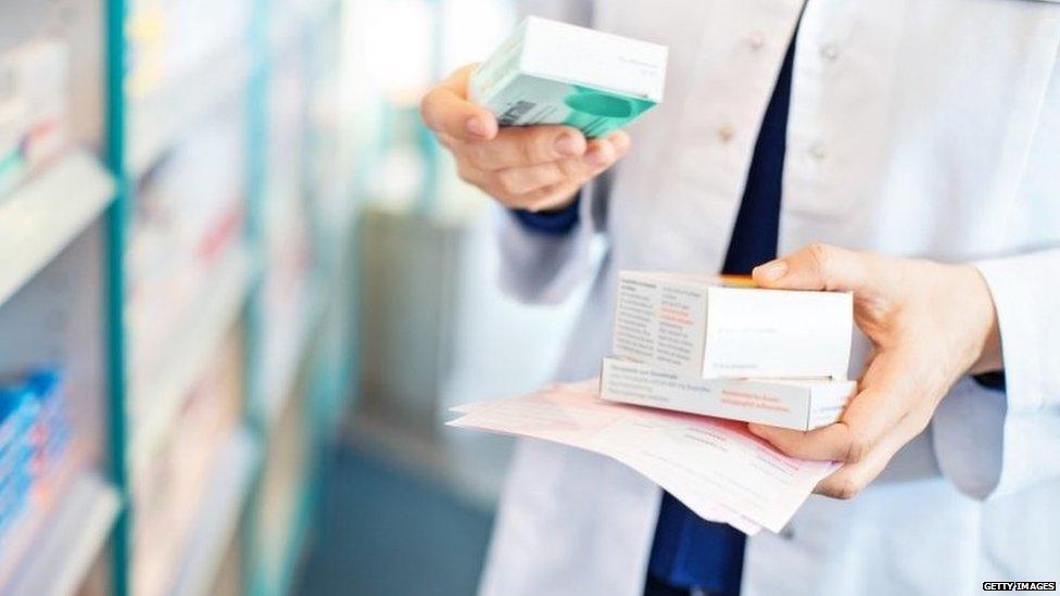 Pharmacist holding medicines