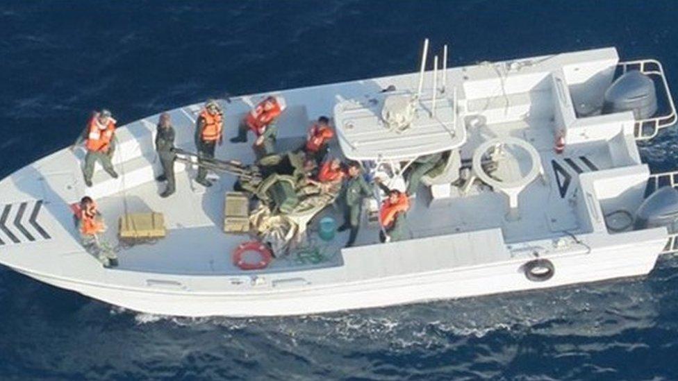 US Department of Defense: Imagery taken from a U.S. Navy MH-60R helicopter of the Islamic Revolutionary Guard Corps Navy after removing an unexploded limpet mine from the M/T Kokuka Courageous.