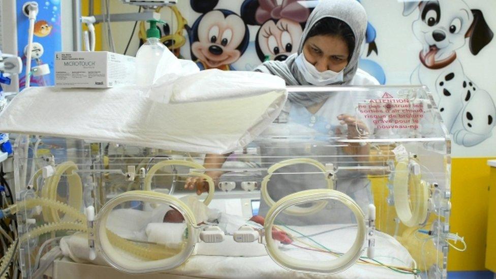 A medic attending to one of the nonuplets in a clinic in Casablanca, Morocco