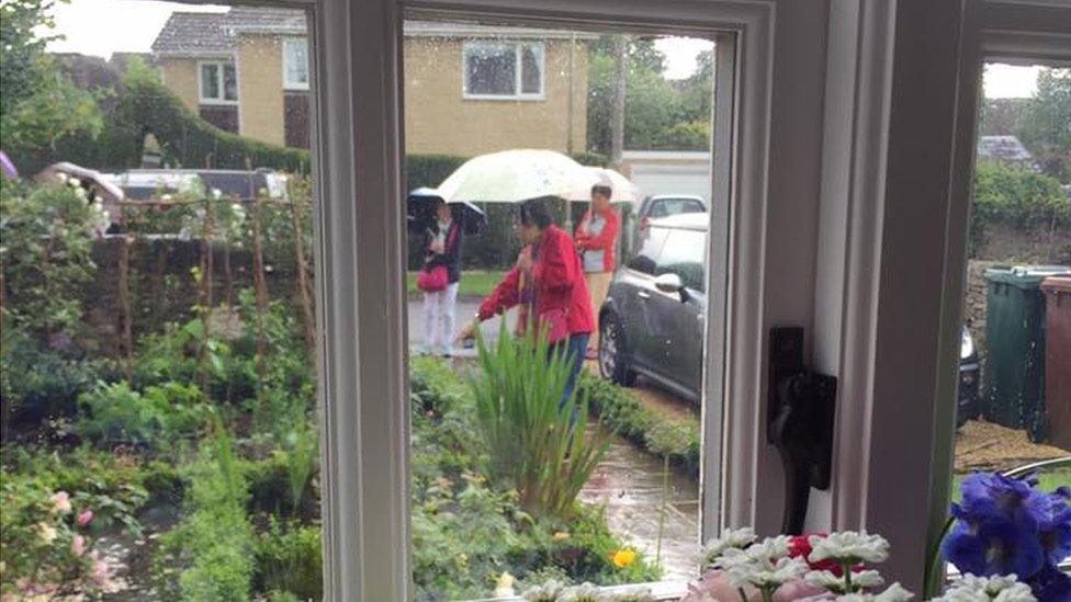 Sightseers in people's front gardens