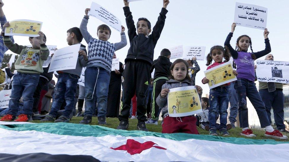 Syrian children carry placards as they call for the lifting of the siege off Madaya and Zabadani towns in Syria, in front of the offices of the U.N. headquarters in Beirut, Lebanon December 26, 2015.