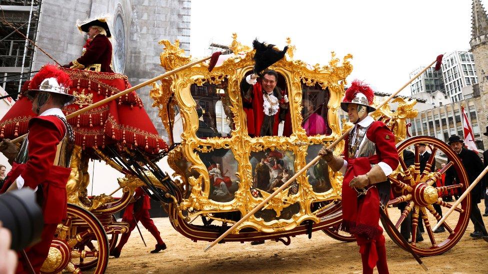 The new Lord Mayor of London, Vincent Keaveny, waves from his carriage during the Lord Mayor"s Show, in London