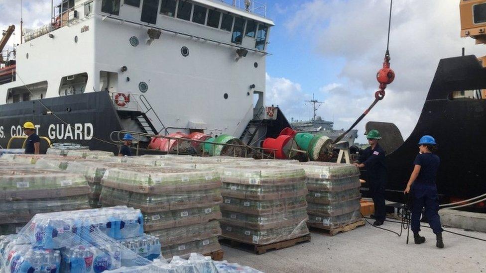 Handout photograph shows supplies being loaded on US coast guard vessel