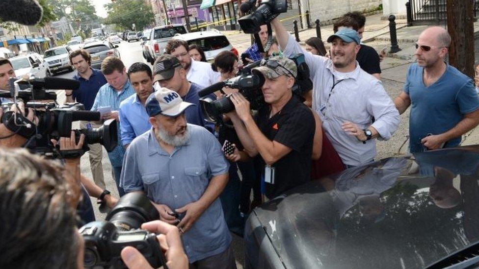 The father of Ahmed Rahami, Mohammad Rahami, center left, comes out from his home, in Elizabeth, New Jersey.