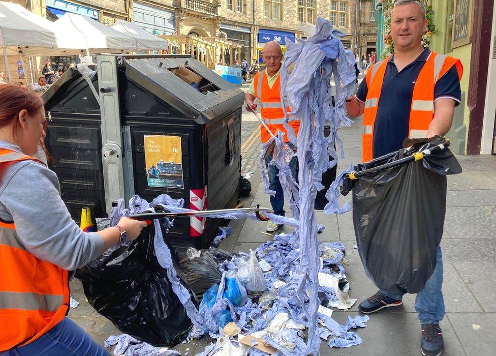 Jill, Stephen and Chris picking up rubbish in Cockburn Street in Edinburgh