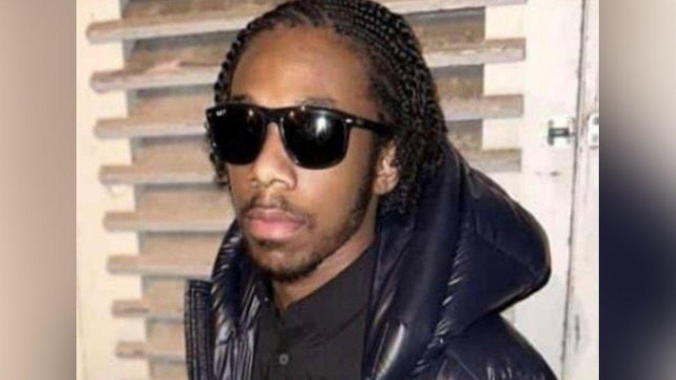 Image of Ronaldo Scott wearing black sunglasses and a black puffer jacket.