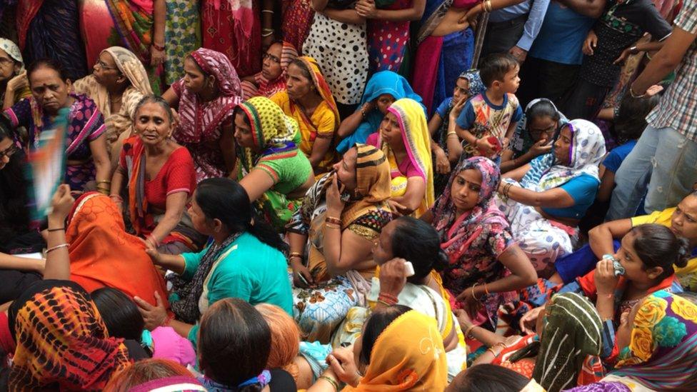 Crowds outside the Prajapati home