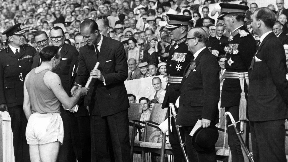 Ken Jones hands Queen's Baton to Duke of Edinburgh at the opening of the Empire Games at Cardiff Arms Park in 1958