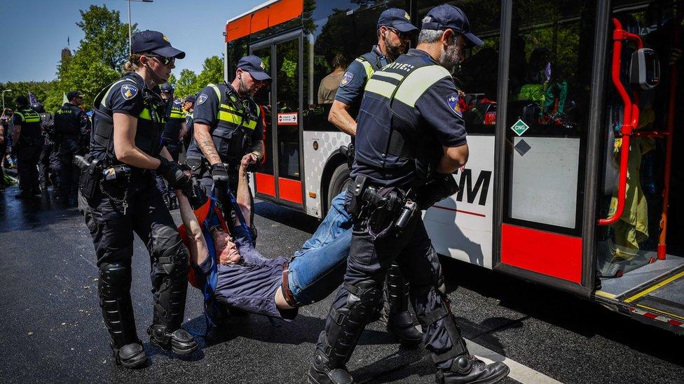 Police officers remove activists from Extinction Rebellion blocking the A12 in The Hague, Netherlands, 27 May 2023. With the action, Extinction Rebellion wants to make the Dutch government know it opposes fossil subsidies. During the most recent blockade on 11 March some 700 activists were arrested.