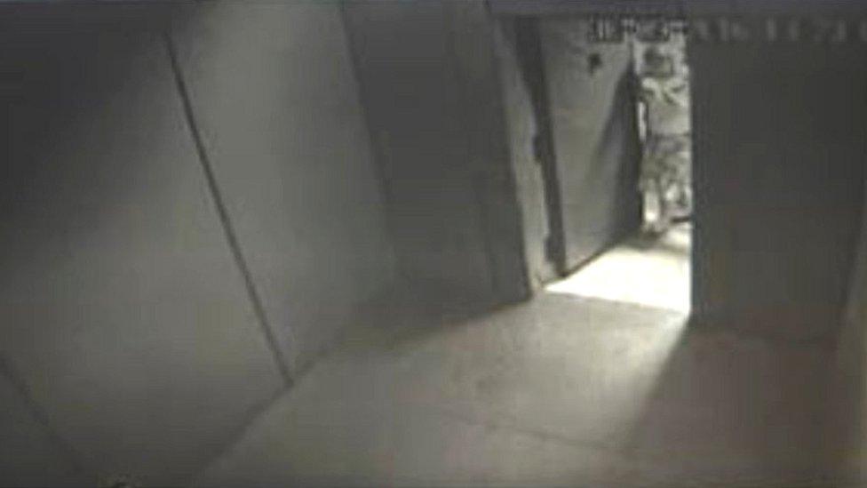 Still of an empty solitary room taken from CCTV footage.