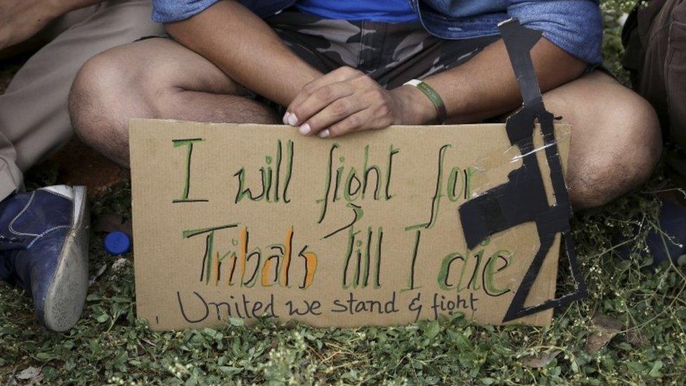 A member of Manipur Tribal Union holds a placard during a protest in Bangalore on 4 Sept 2015