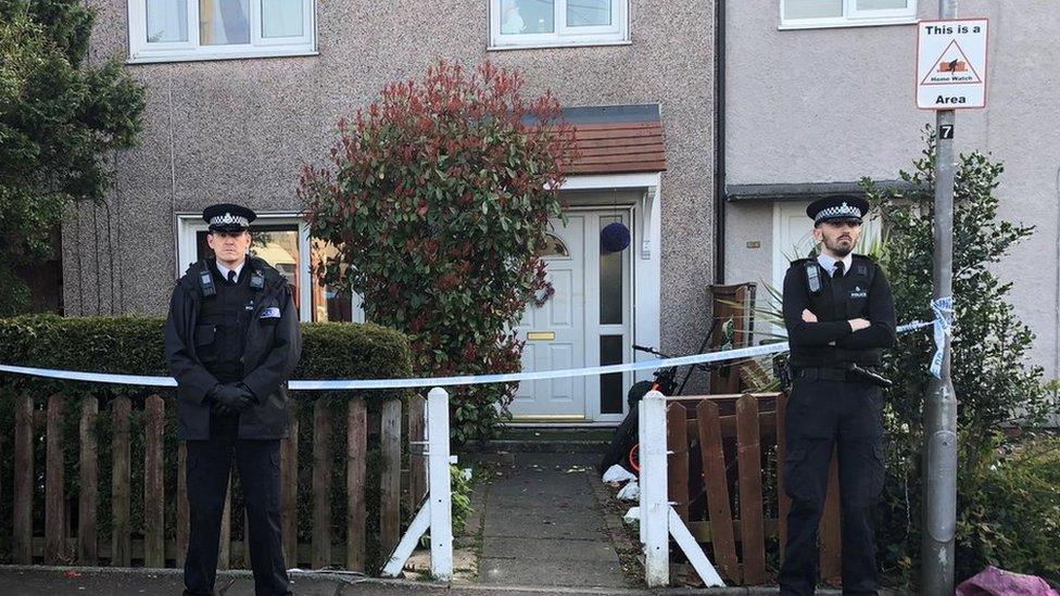 Police officers outside house