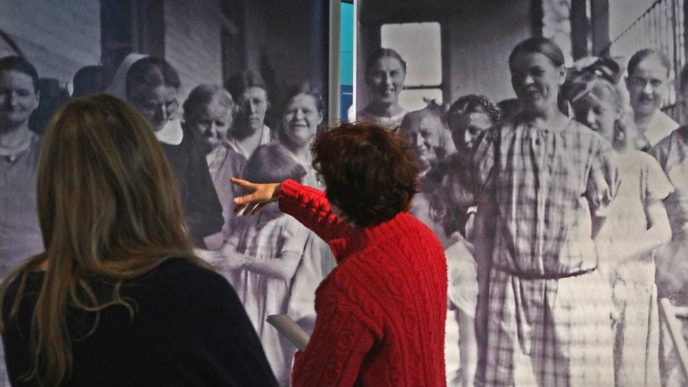 Visitors look at a photo of victims of the 'Aktion T4' Project, the policy leading to extermination of the disabled during the Holocaust,