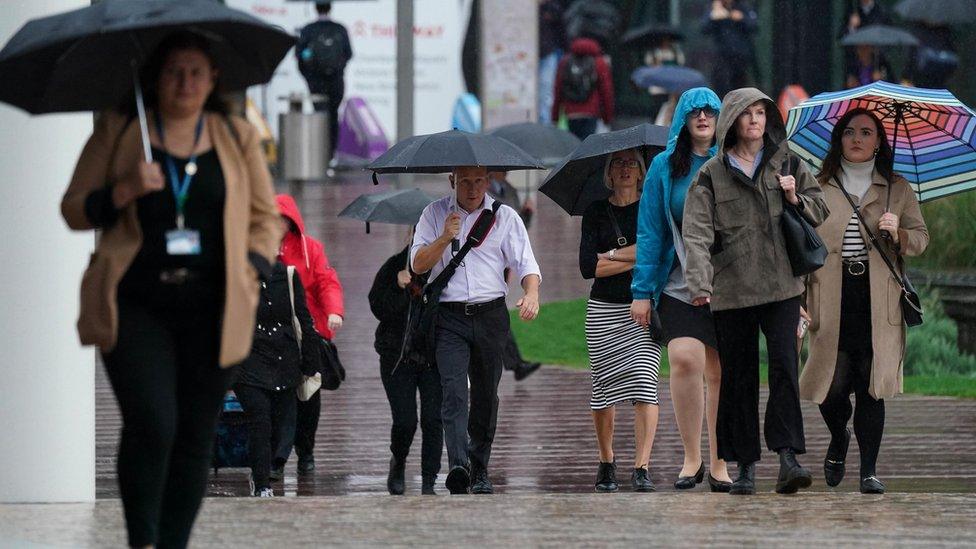 People walking with umbrellas