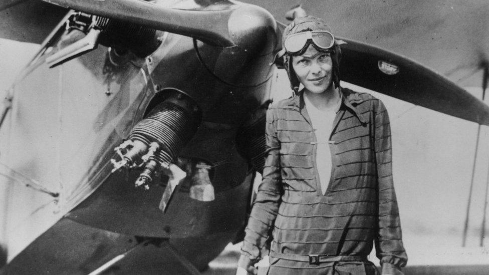 Amelia Earhart in front of a plane