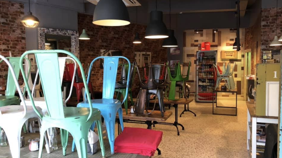 Chairs stacked on tables in an empty cafe