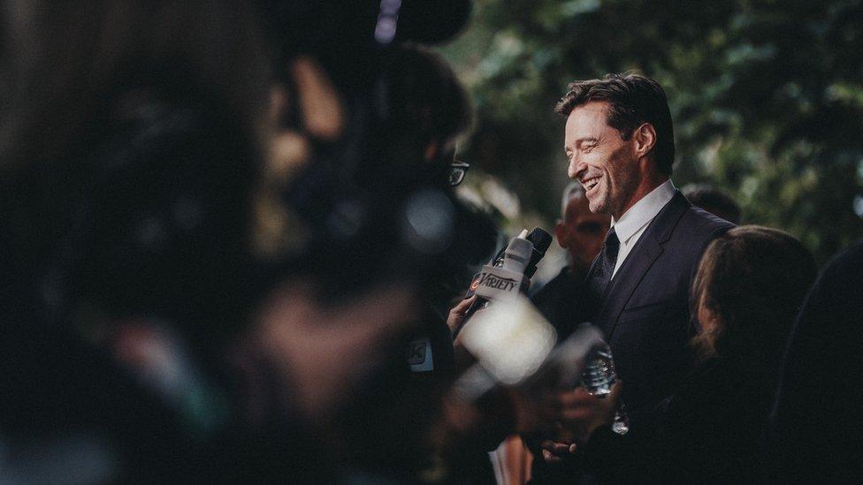 Hugh Jackman talks to the press outside the premiere of The Front Runner