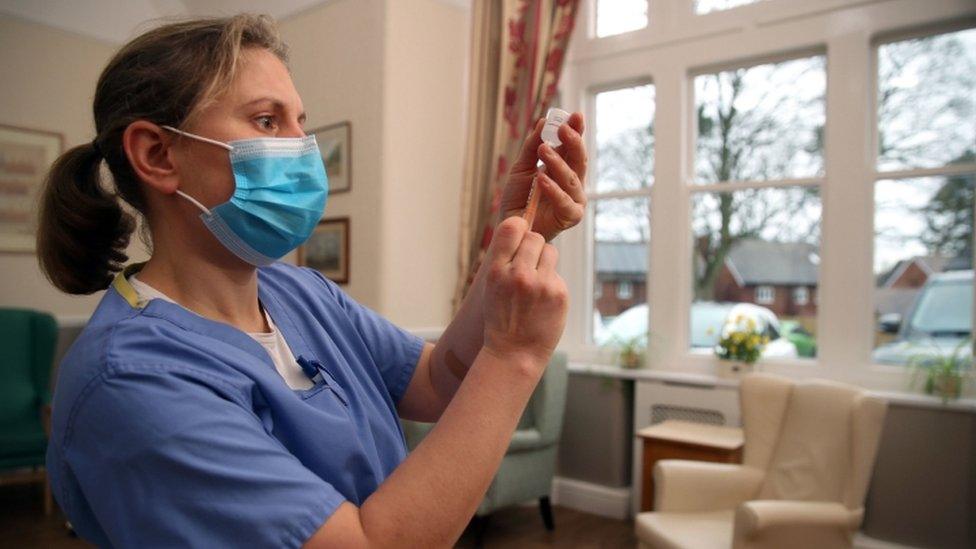 A medic prepares to give a dose of the vaccine at a nursing home in Shropshire