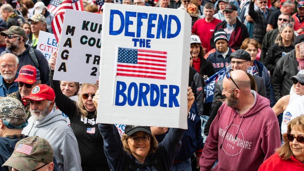 Woman holding sign at rally