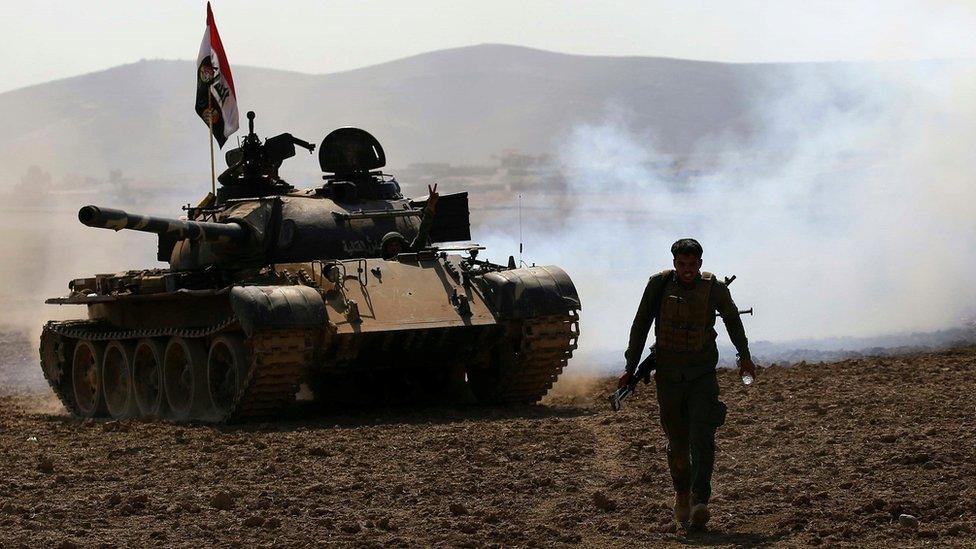 Iraqi government forces advance in the village of Badoush, some 15km northwest of Mosul, during the battle to retake the city's west from so-called Islamic State (IS), 8 March 2017