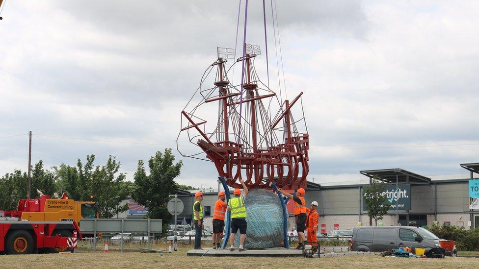 The sculpture is placed on its globe base