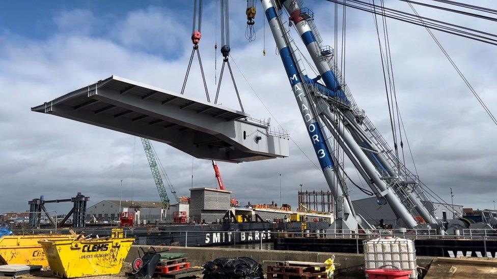 A bridge span being craned into place on the Herring Bridge