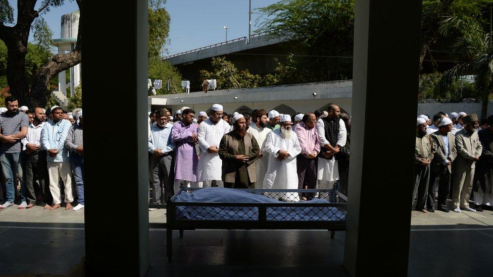 Assembled Muslims are seen offering prayers at the burial of Syed Shahabuddin in New Delhi, 4 March 2017