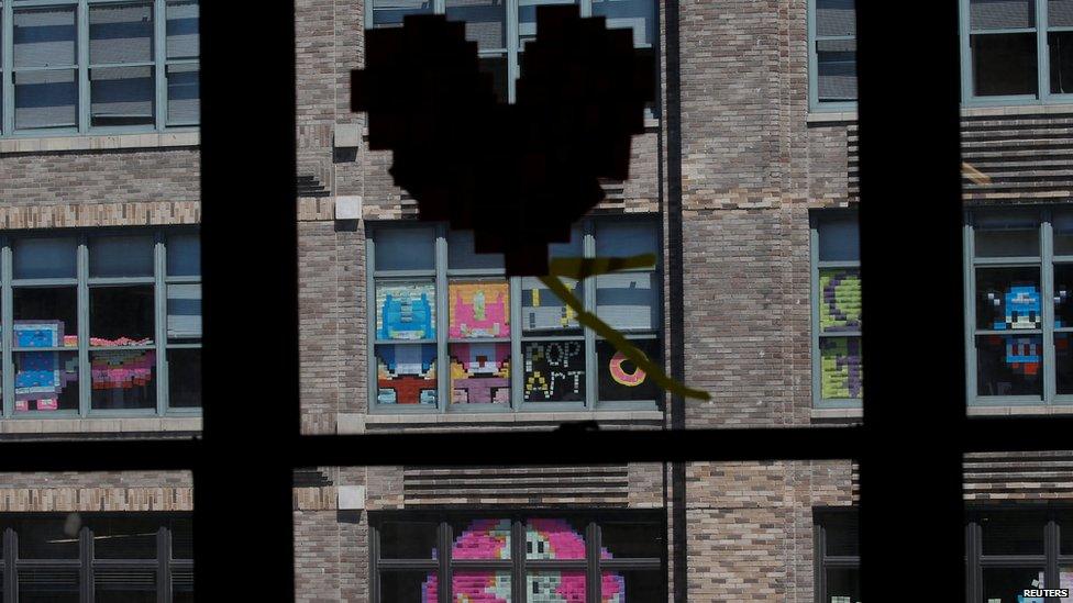 Heart made from sticky notes on window