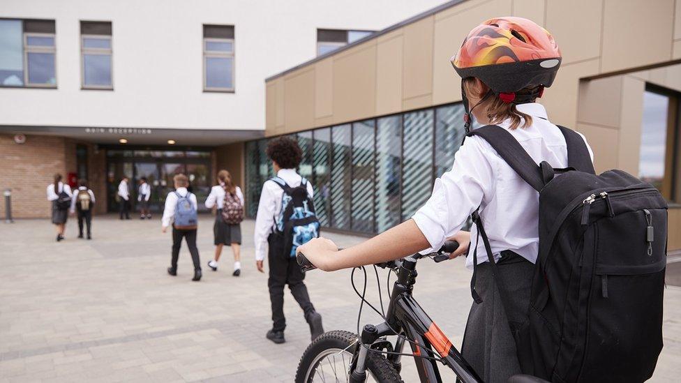 girl-with-bike-going-to-school.