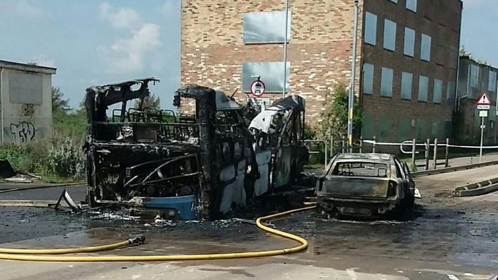 Burnt-out bus and car