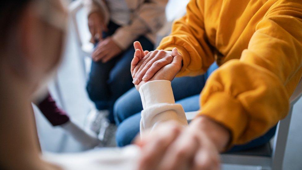 File image of two people holding hands