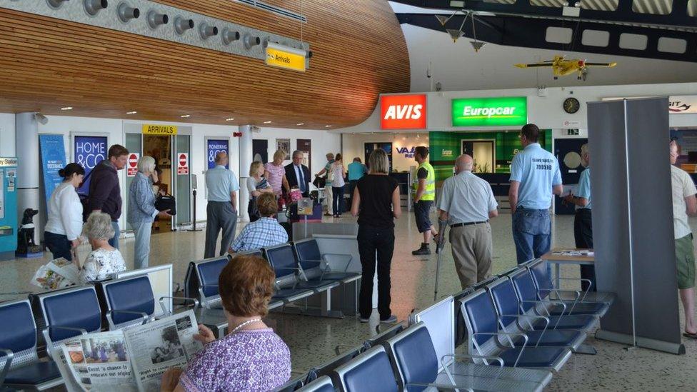 People stood in airport hall