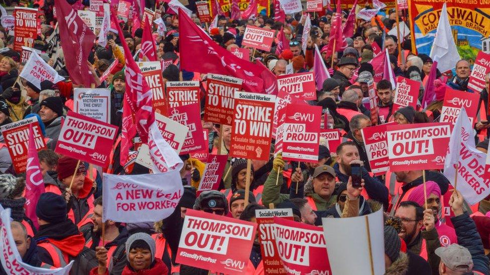 Thousands of postal workers at a huge rally in London, holding placards demanding that Royal Mail CEO Simon Thompson resigns