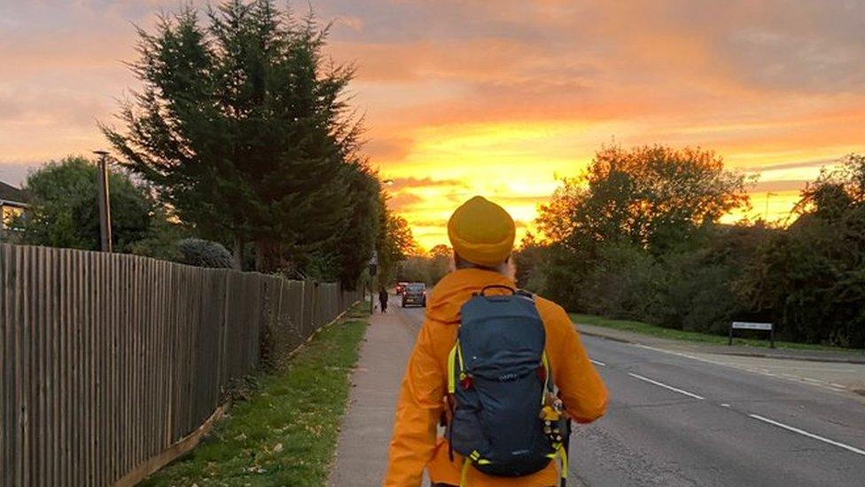 Manny Singh Kang walking at sunset