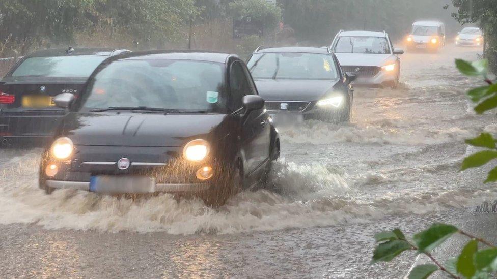 Cars driving through flood