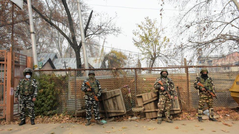 Indian forces stand alert outside a voting booth in Srinagar on 01 December 2020.