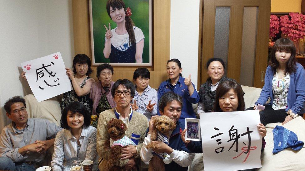 Top row from left: Narita's wife Hiromi, her mother, her friend, the Tanno sisters (bereaved families), Tamura daughters (bereaved families) Below from left: Takamatsu, journalist, Narita, Mr & Mrs Tamura (bereaved families) - the signs say "Thank you"