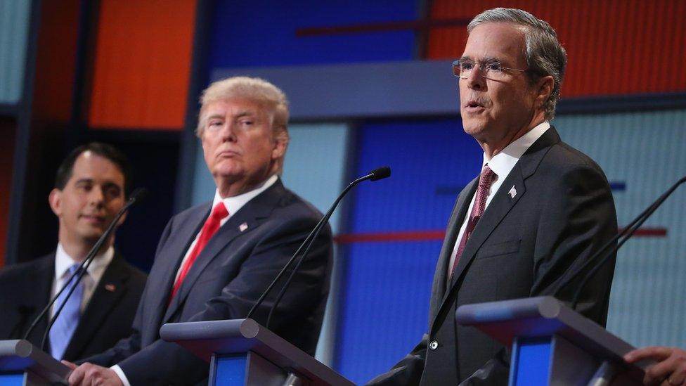 Republican presidential candidates (L-R) Wisconsin Gov. Scott Walker, Donald Trump and Jeb Bush participate in the first prime-time presidential debate hosted by FOX News and Facebook at the Quicken Loans Arena August 6, 2015 in Cleveland, Ohio.