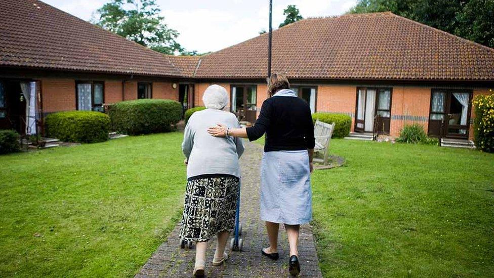 old lady and helper in residential care complex