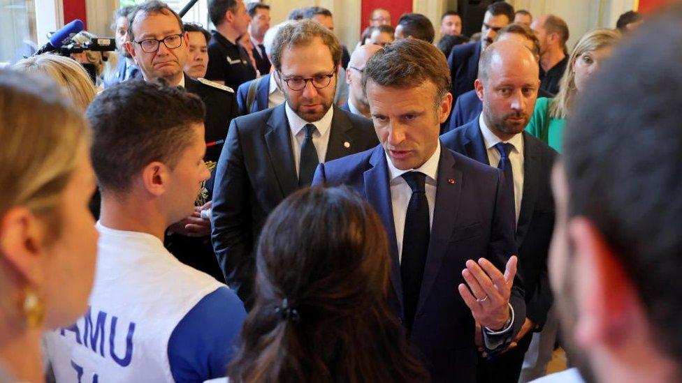 President Emmanuel Macron speaks to rescue workers