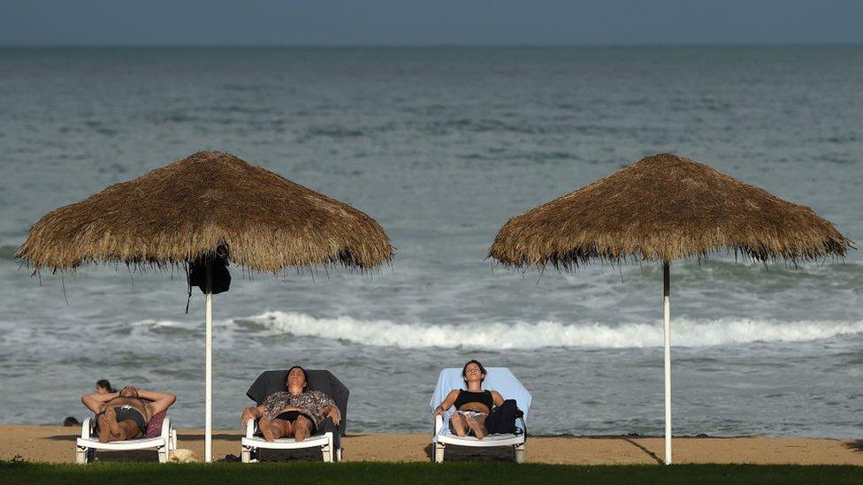 Tourists relaxing on a beach in Sri Lanka