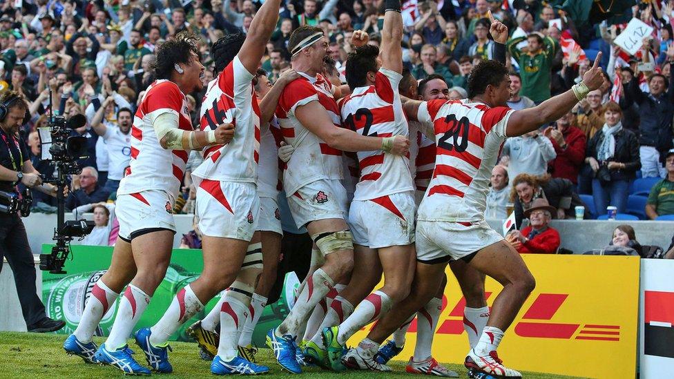 Japan players celebrate after their victory against South Africa