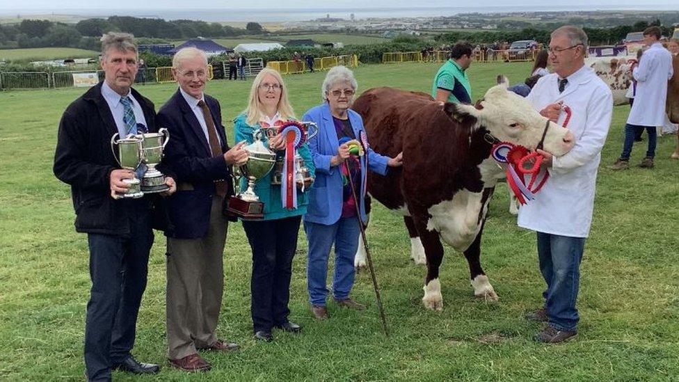 Derek Griffin with the Hereford heifer and show organisers with the trophys