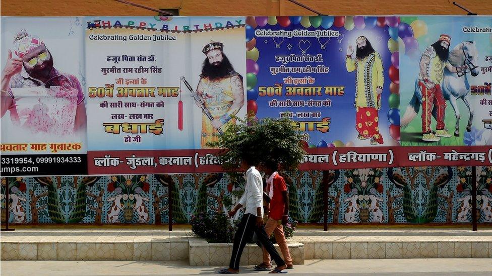 In this photo taken on August 27, 2017 followers of the controversial Indian guru Ram Rahim Singh walk outside the 'Dera Sacha Sauda' ashram in Sirsa.