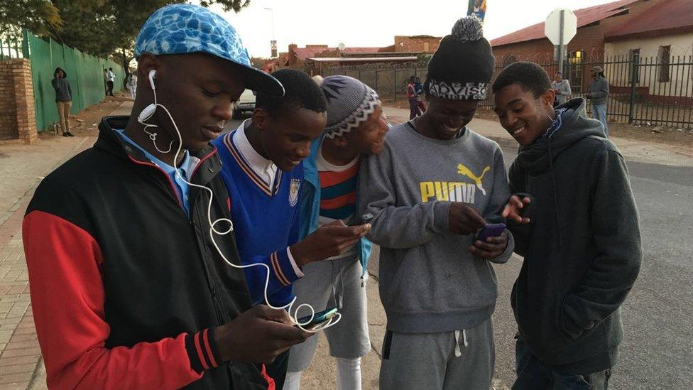 People using their phones in free wi-fi zone